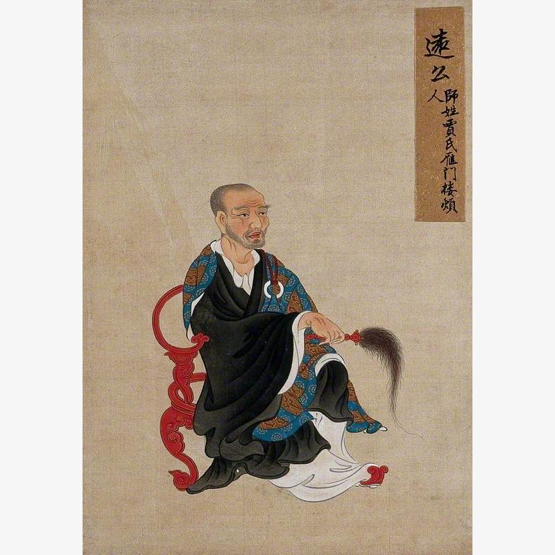 A Seated Chinese Figure Wearing Black Robes with a Fly Whisk